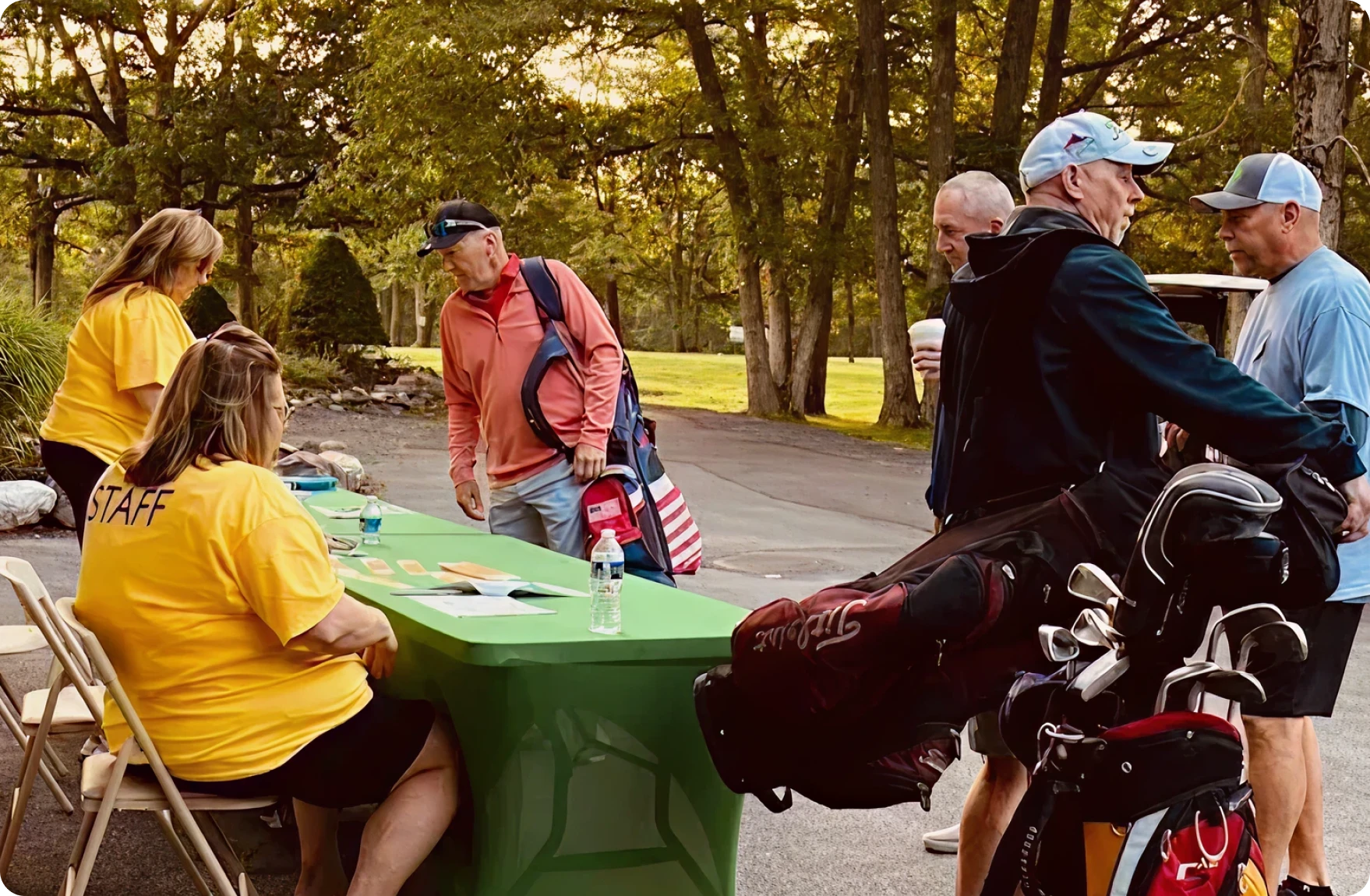 People gathering with golf gear