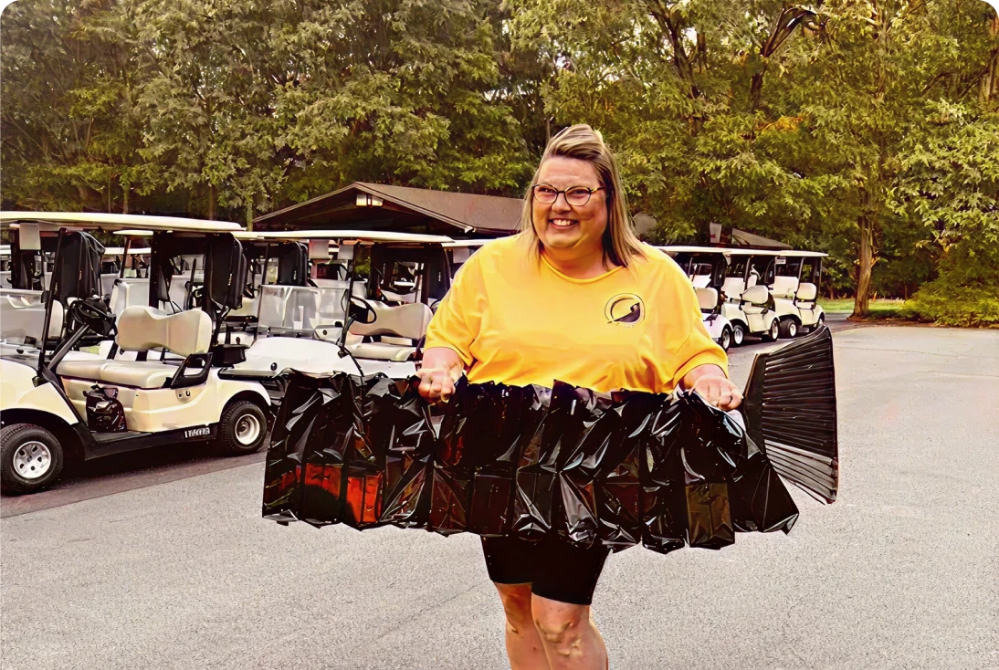 Smiling woman with black bags outdoors